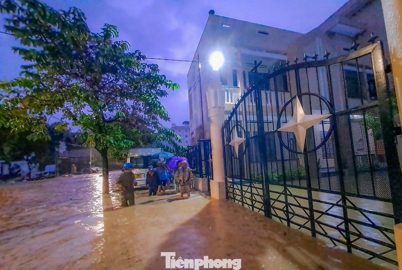 Ngập tại khu vực phường Ghềnh Ráng, người dân di chuyển ra khỏi vùng bị ngập (đây cũng là khu vực thường xuyên xảy ra tình trạng ngập mỗi khi có mưa lớn). Ảnh: Trương Định