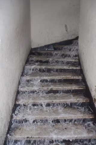 Nước chữa cháy thoát theo đường cầu thang tuôn như thác. Ảnh: Vietnamnet Nước chữa cháy thoát theo đường cầu thang tuôn như thác