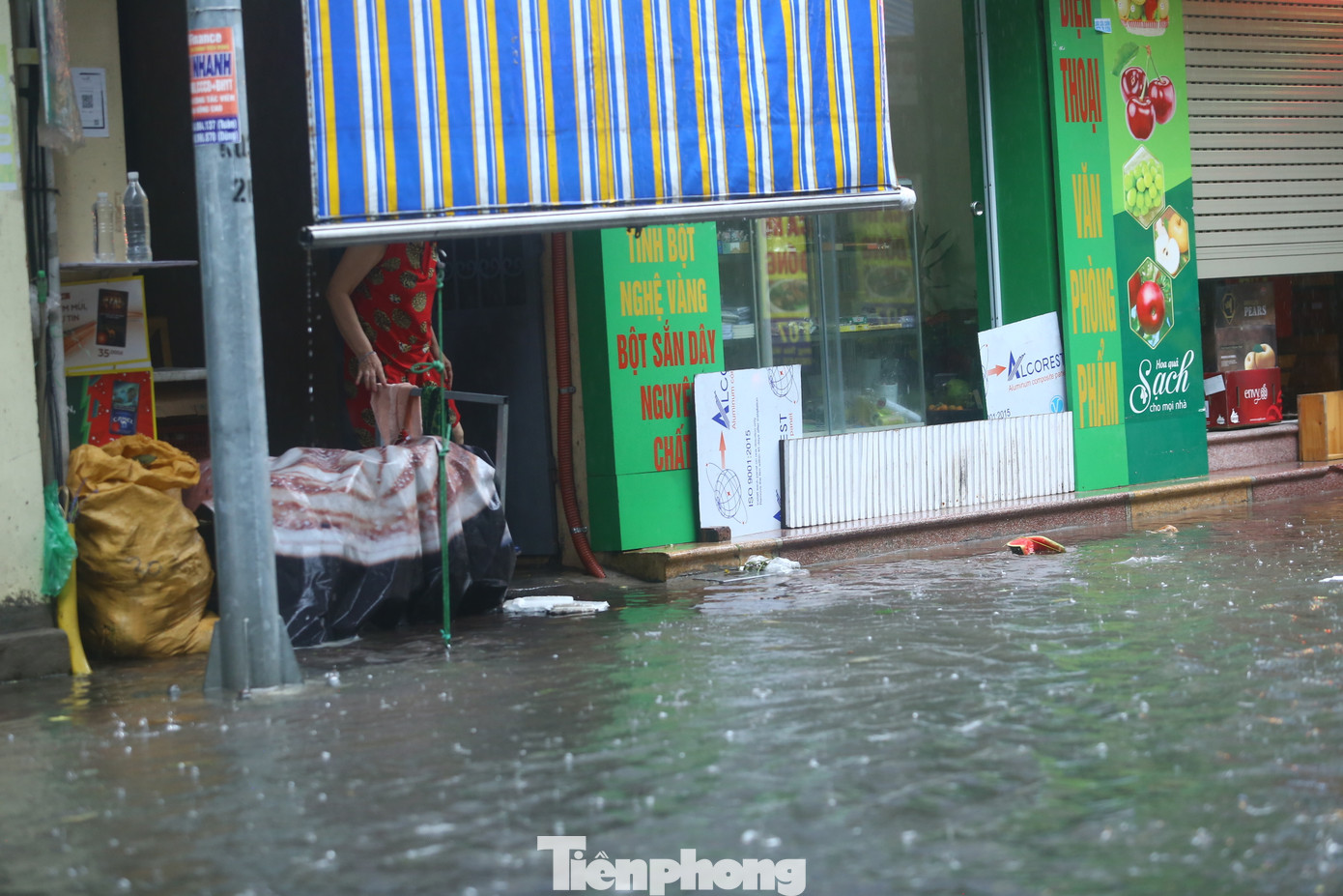 Người dân liên tục chắn cửa nhà bằng những tấm biển lớn để ngăn không cho nước vào nhà.