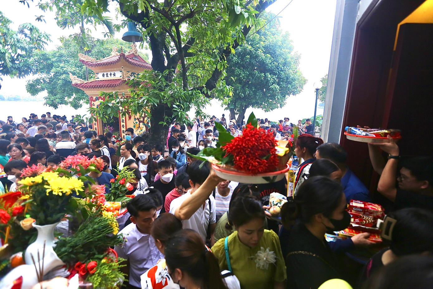 Những mâm cỗ đều được người dân đưa lên cao qua đầu để đưa vào trong điện chính.