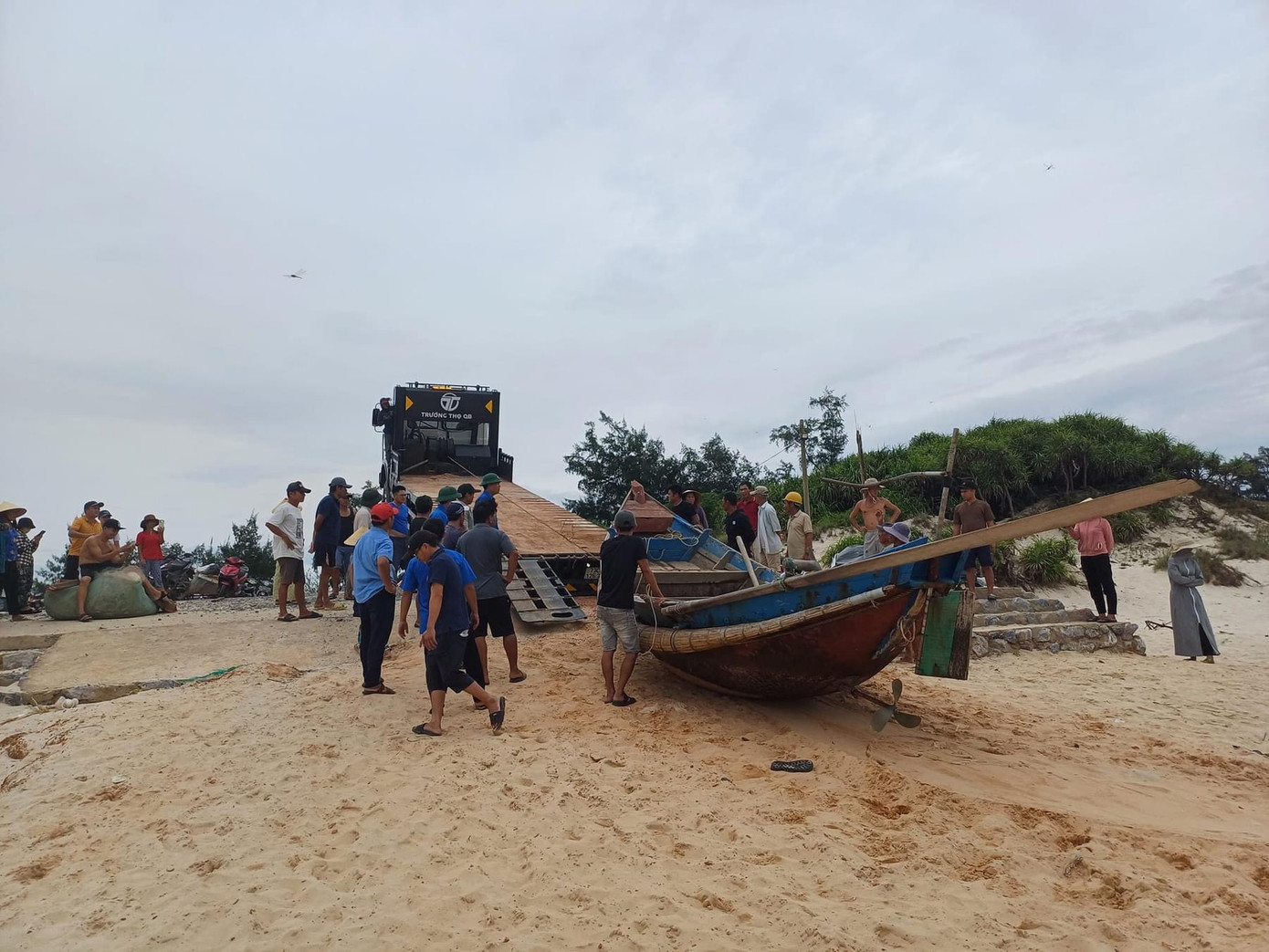 Ngư dân Ngư Thuỷ Bắc hỗ trợ nhóm anh Hùng cẩu bơ nan lên ô tô để ra Bắc. Ảnh Truyền hình Lệ Thuỷ.