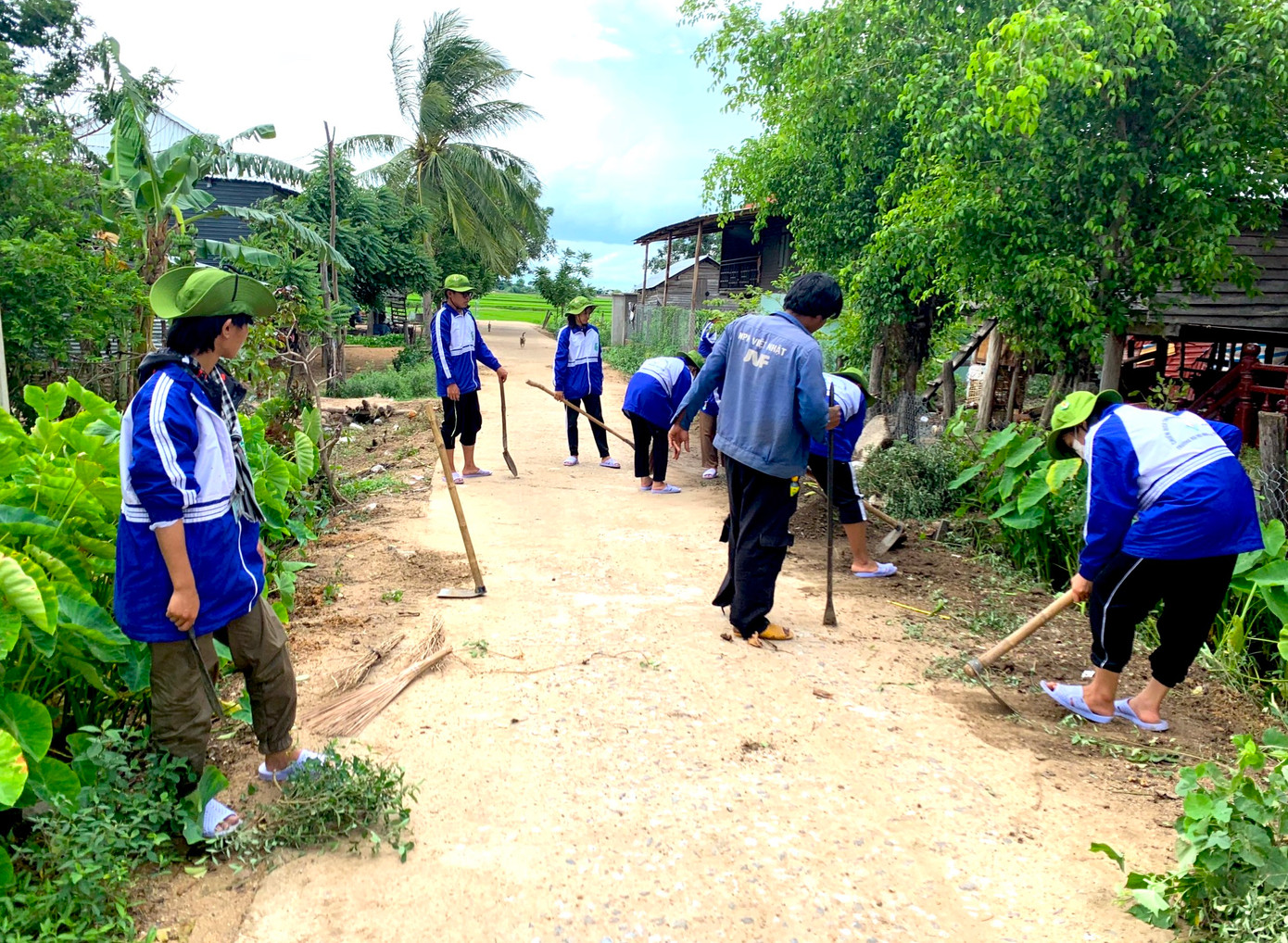 Các thanh niên tình nguyện dọn dẹp đường quê, tặng quà cho các em nhỏ ở buôn làng