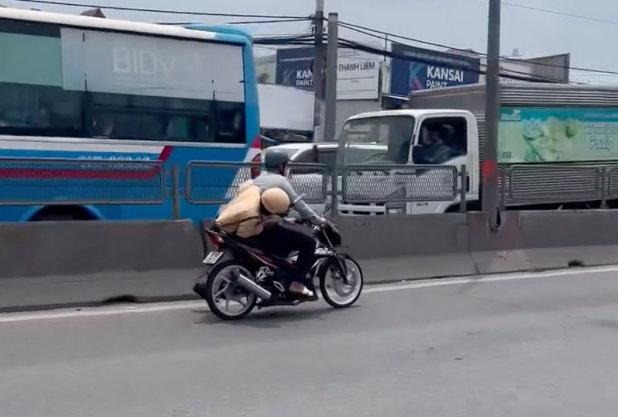 Hình ảnh Tài bỏ chạy khiến CSGT đu bám chới với trên yên xe. Ảnh cắt từ clip. Hình ảnh Tài bỏ chạy khiến CSGT đu bám chới với trên yên xe. Ảnh cắt từ clip.