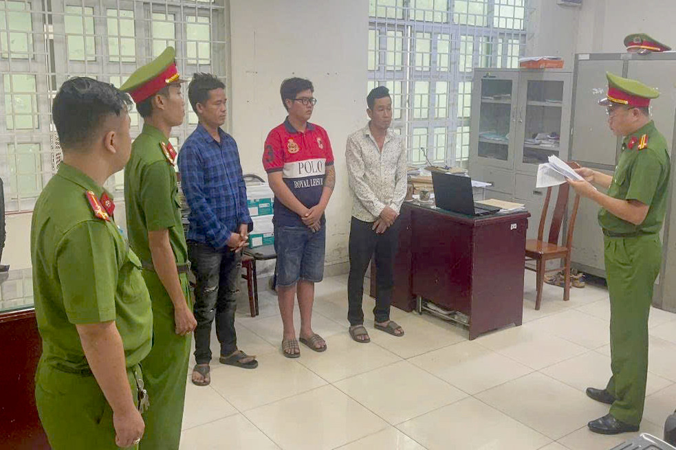 Cơ quan công an tống đạt các quyết định với Đơn (đeo kính), Tuấn (áo sơmi màu xanh) và Bé. Ảnh: C.A.