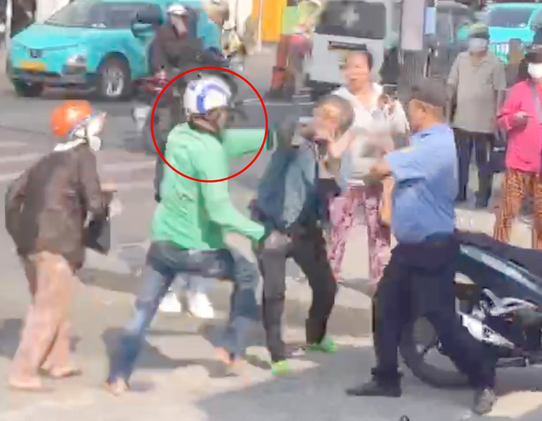 Tài xế xe ôm công nghệ (khoanh tròn đỏ) cầm dao rượt đánh tài xế xe ôm truyền thống. Ảnh cắt từ clip.