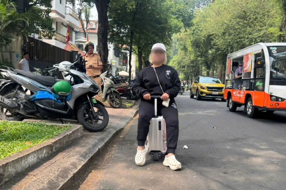 Bà T. điều khiển vali điện trên đường Lê Duẩn. Ảnh: PC08.