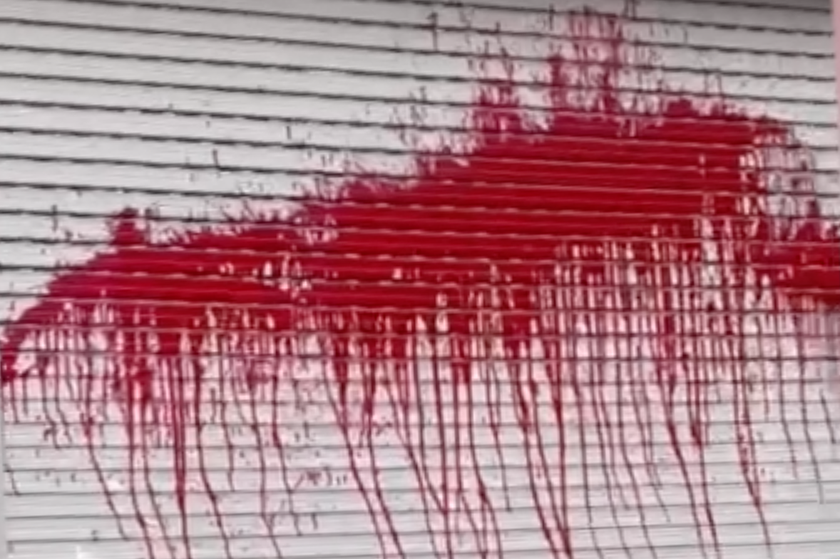 Cửa cuốn nhà bà V bị tạt sơn. Ảnh: Công an cung cấp.