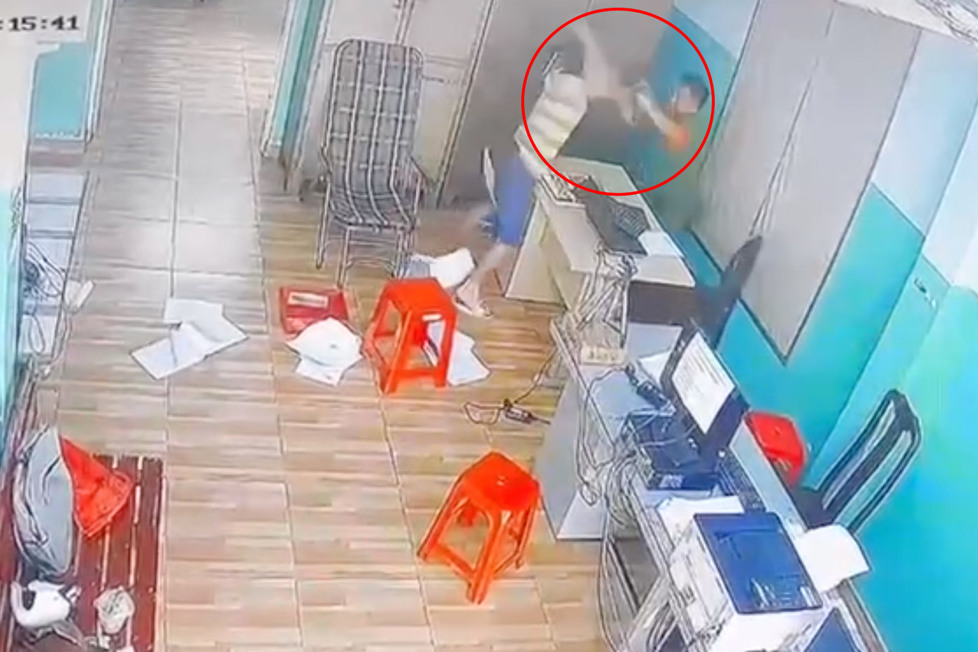 Người đàn ông cầm hung khí tấn công cán bộ công an trực ban (Ảnh cắt từ clip). Người đàn ông cầm hung khí tấn công cán bộ công an trực ban (Ảnh cắt từ clip).