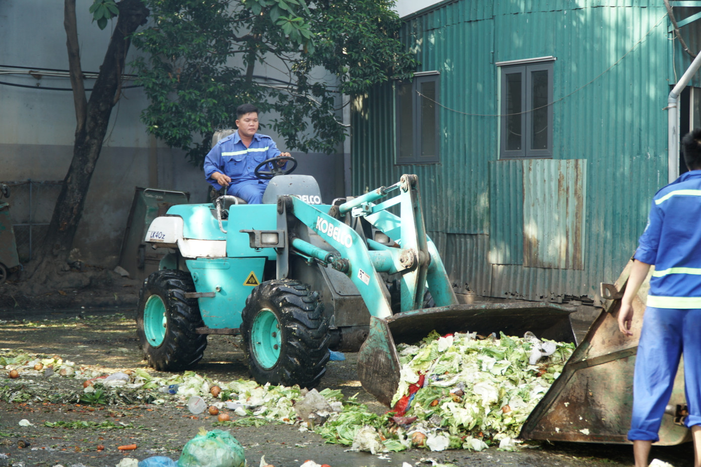 Nhân viên vệ sinh thu gom rác tại Trạm xử lý rác thải chợ ĐMNS Thủ Đức.