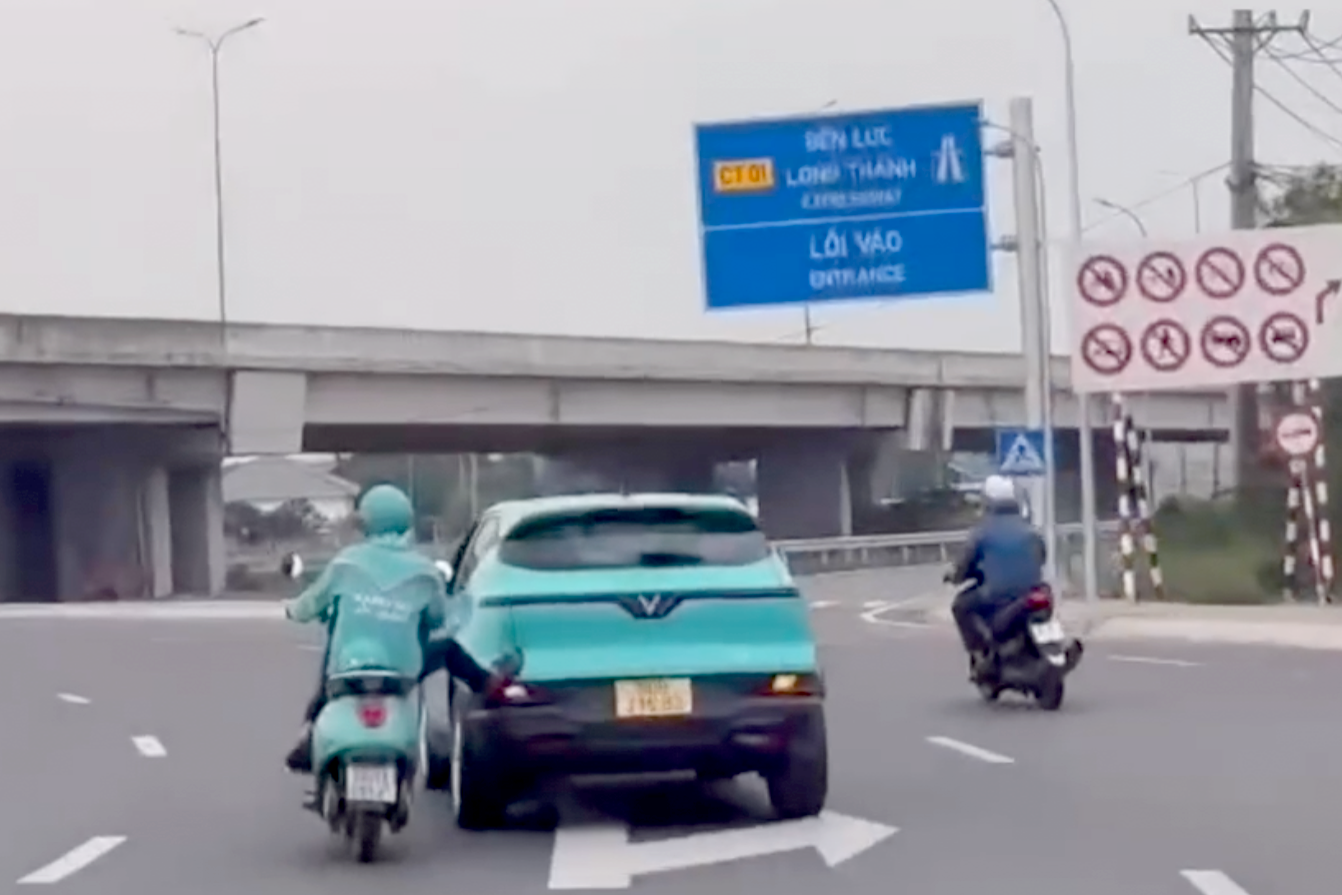 Hình ảnh ông T. dùng chân đẩy ô tô được người dân quay lại. Ảnh cắt từ clip.