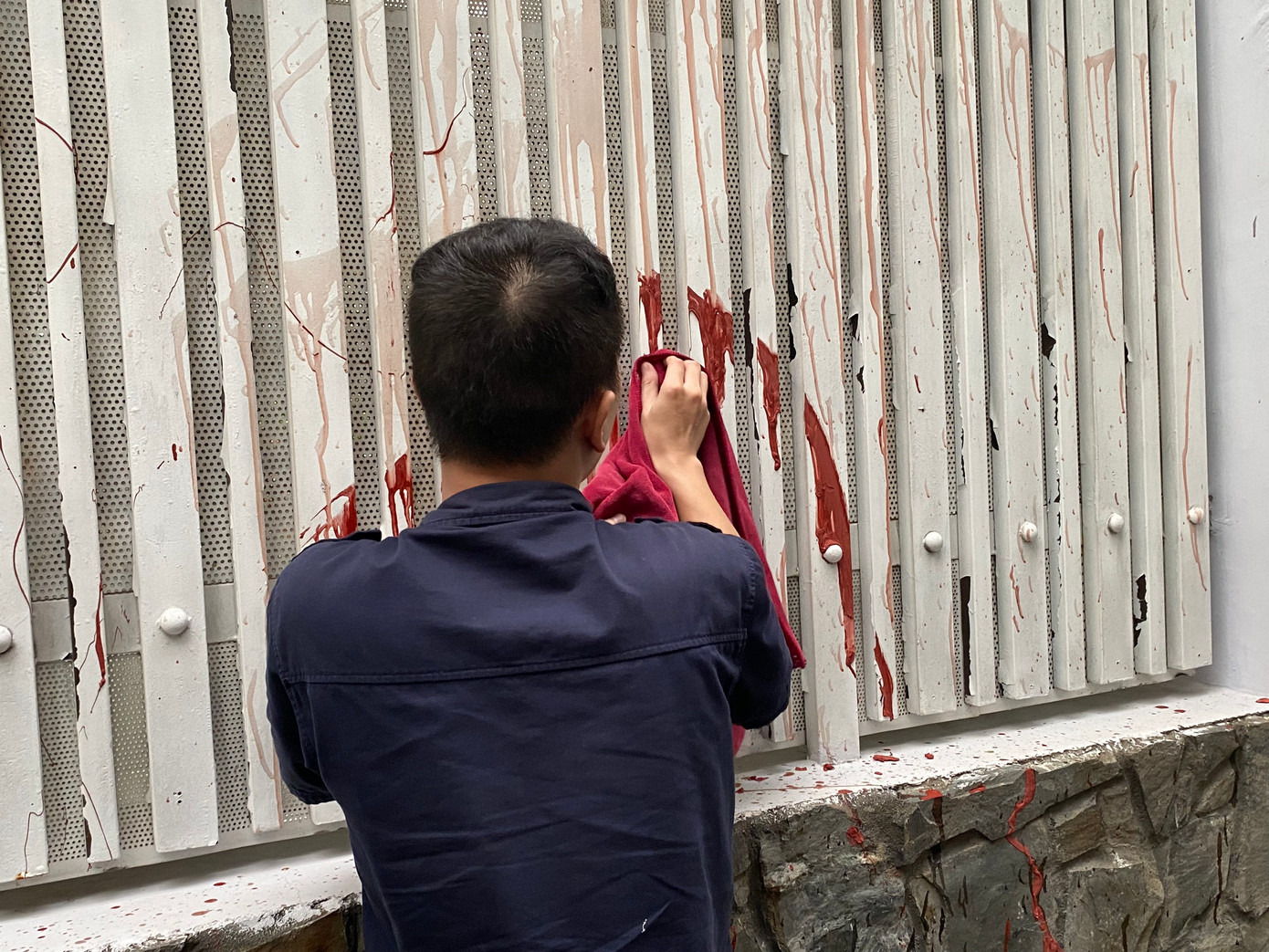 Công an đưa H trở lại hiện trường để lau chùi vết sơn.