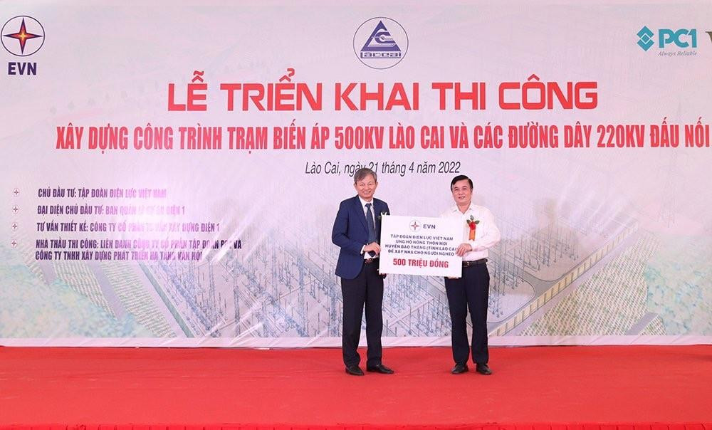 Tổng giám đốc EVN Trần Đình Nhân (bên trái) trao biểu trưng số tiền 500 triệu đồng của Tập đoàn Điện lực Việt Nam ủng hộ huyện Bảo Thắng