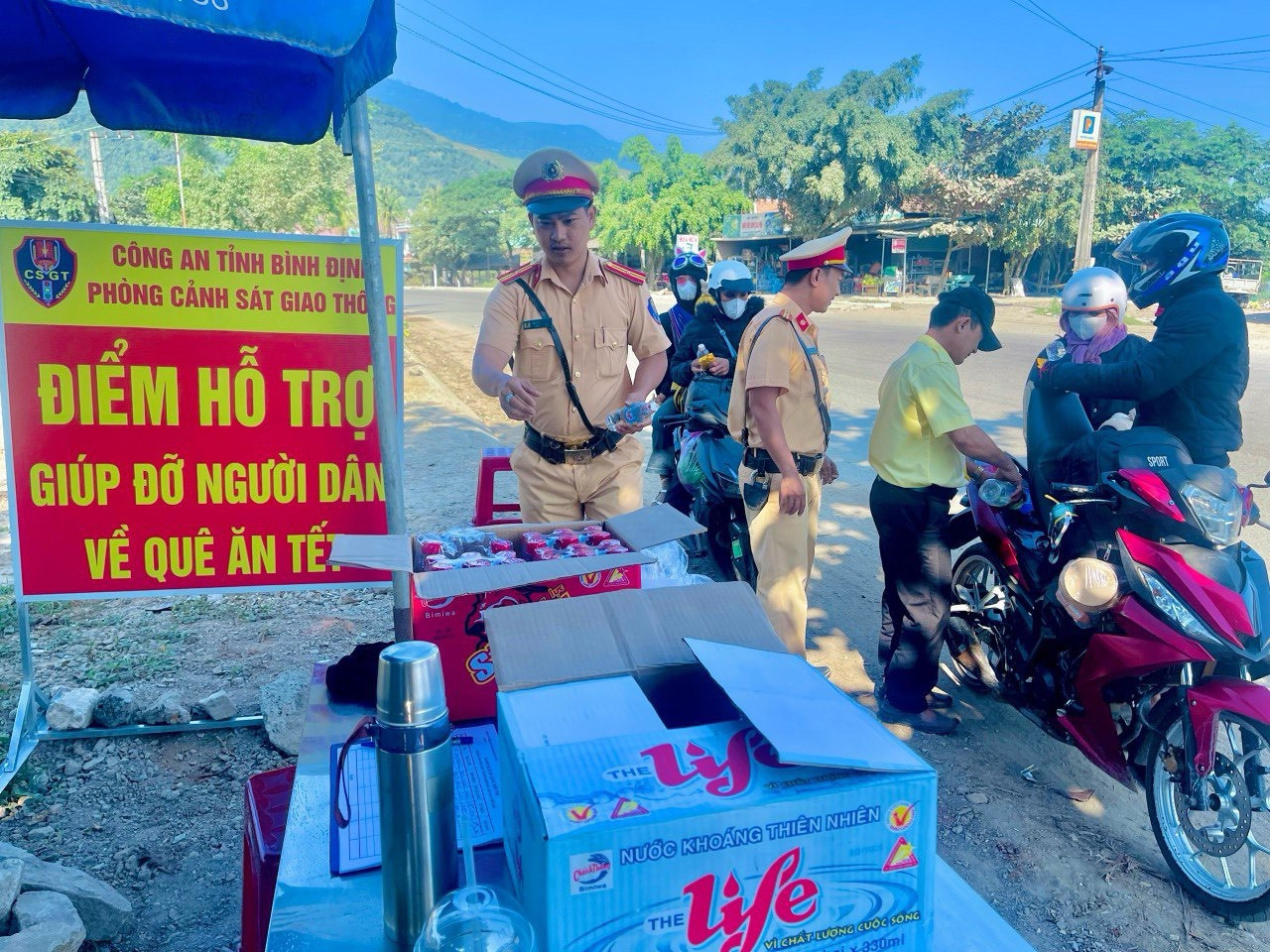 Lực lượng CSGT tỉnh Bình Định giúp đỡ, hỗ trợ người dân.