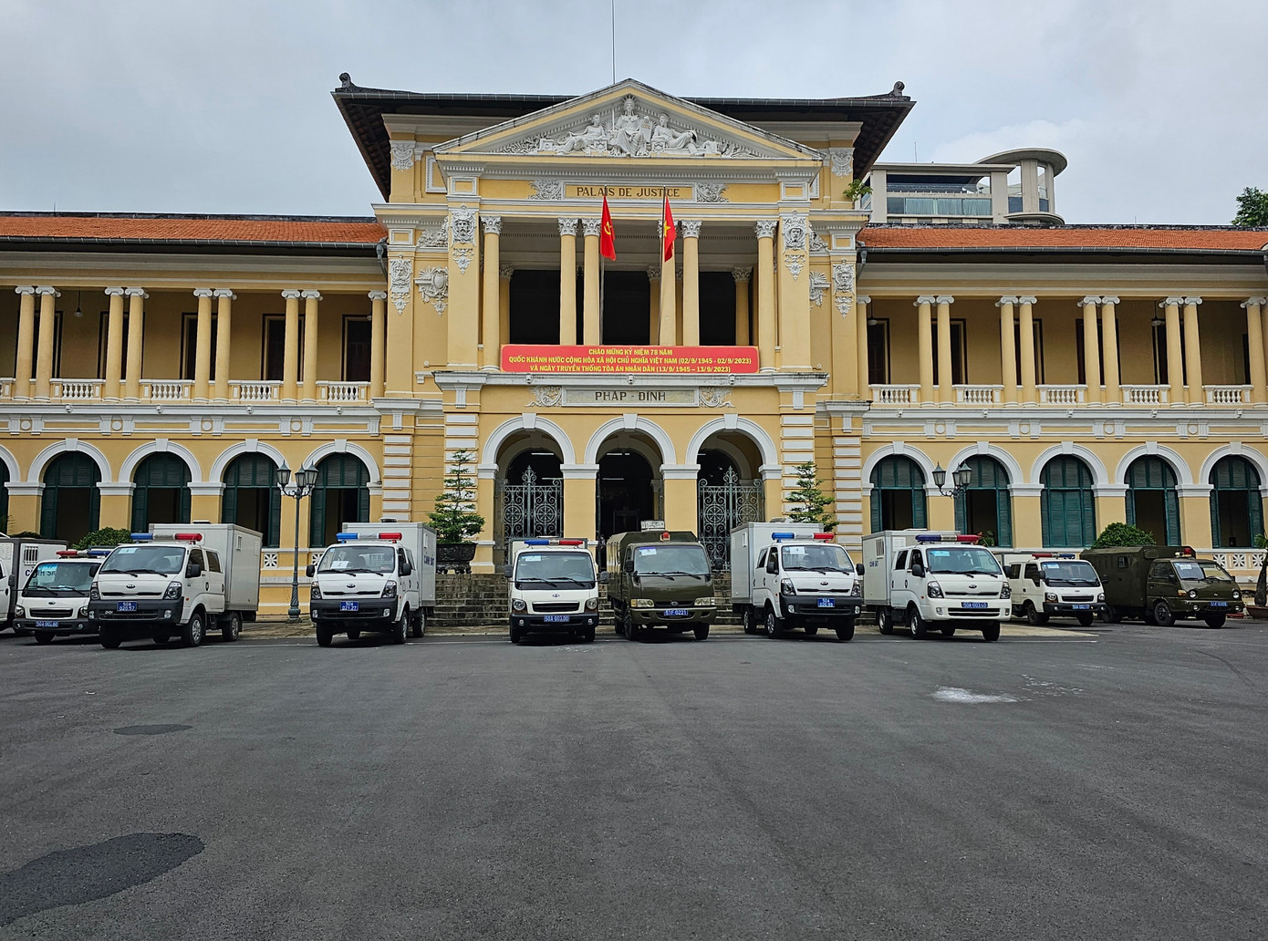 Đoàn xe cảnh sát dẫn giải các bị cáo đến tòa đỗ hàng dài trước sân tòa.