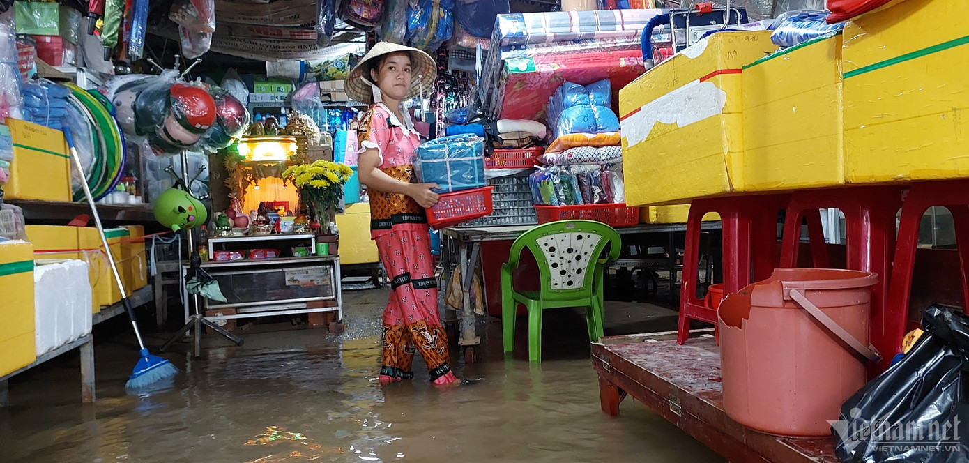 Chị Nguyễn Thị Lệ (tiểu thương) chuyển hàng hoá lên cao để tránh hư hỏng. Chị Nguyễn Thị Lệ (tiểu thương) chuyển hàng hoá lên cao để tránh hư hỏng.