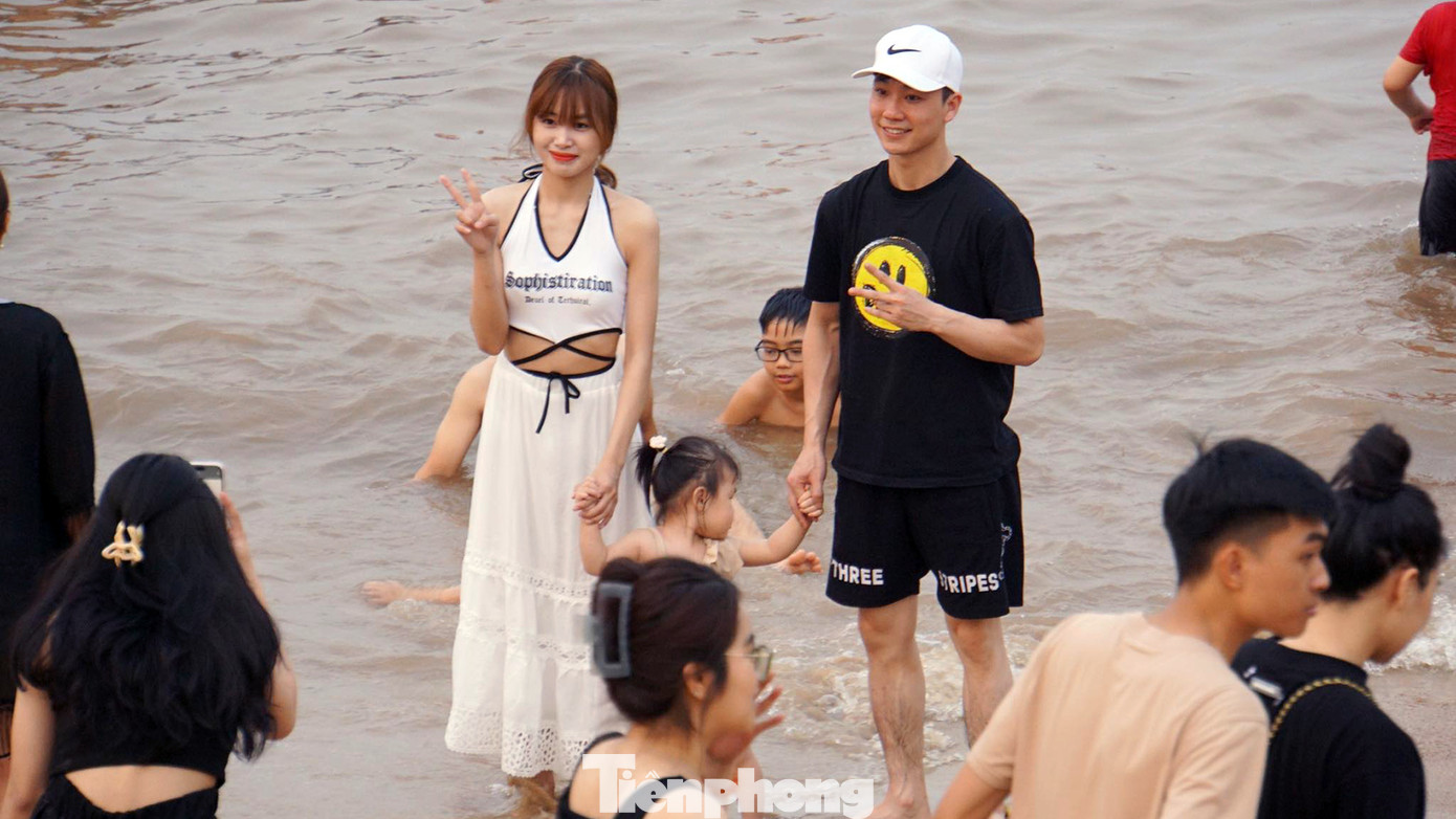 Du khách chụp ảnh lưu niệm ở bãi tắm.