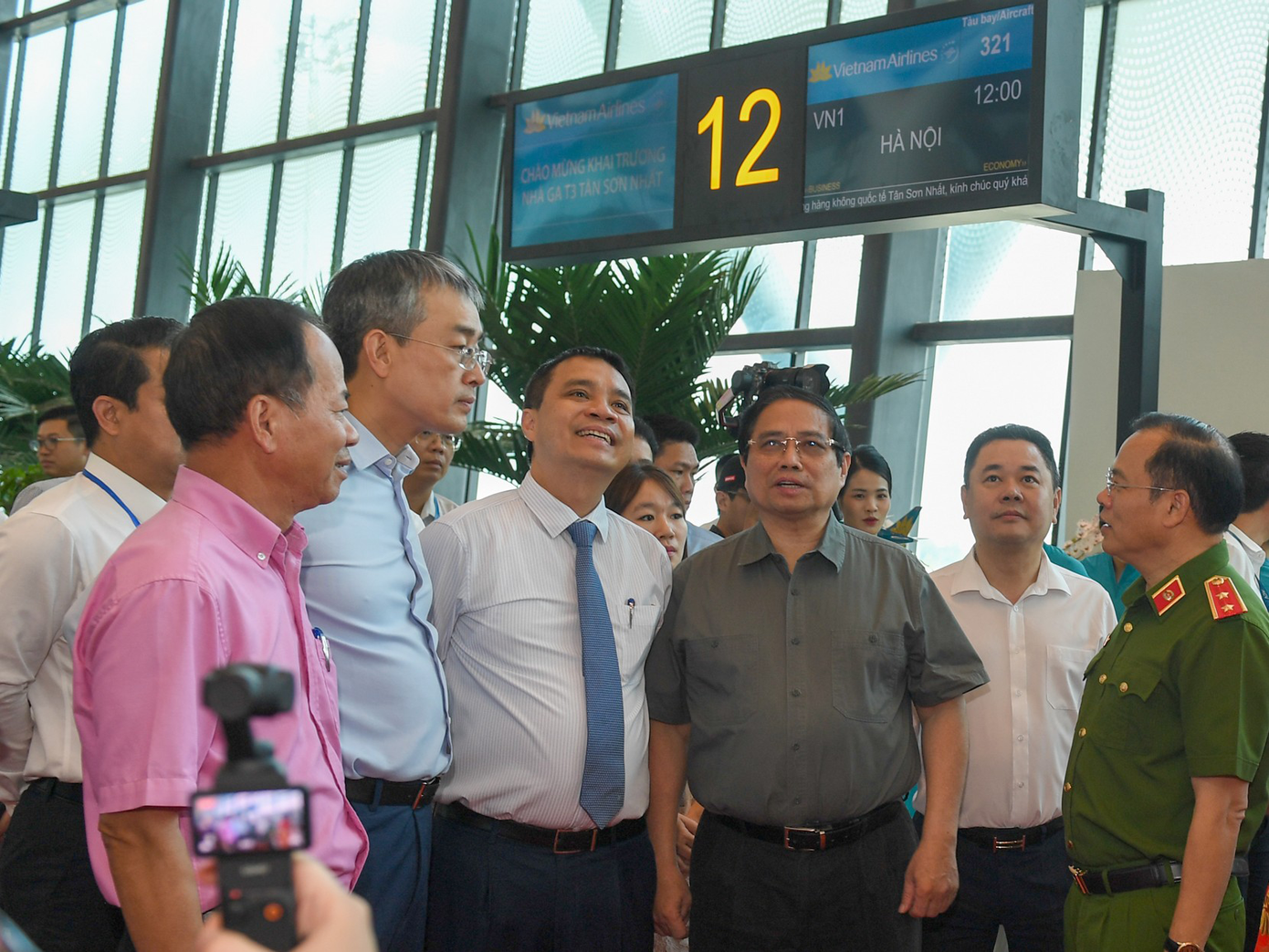 Trước thời điểm máy bay cất cánh, Thủ tướng Phạm Minh Chính cùng lãnh đạo các bộ, ban, ngành đã đến cửa ra máy bay số 12 của chuyến bay VN244 để trực tiếp kiểm tra quy trình làm thủ tục lên máy bay bằng công nghệ sinh trắc học, tích hợp trong ứng dụng VNeID. Ảnh: VNA.