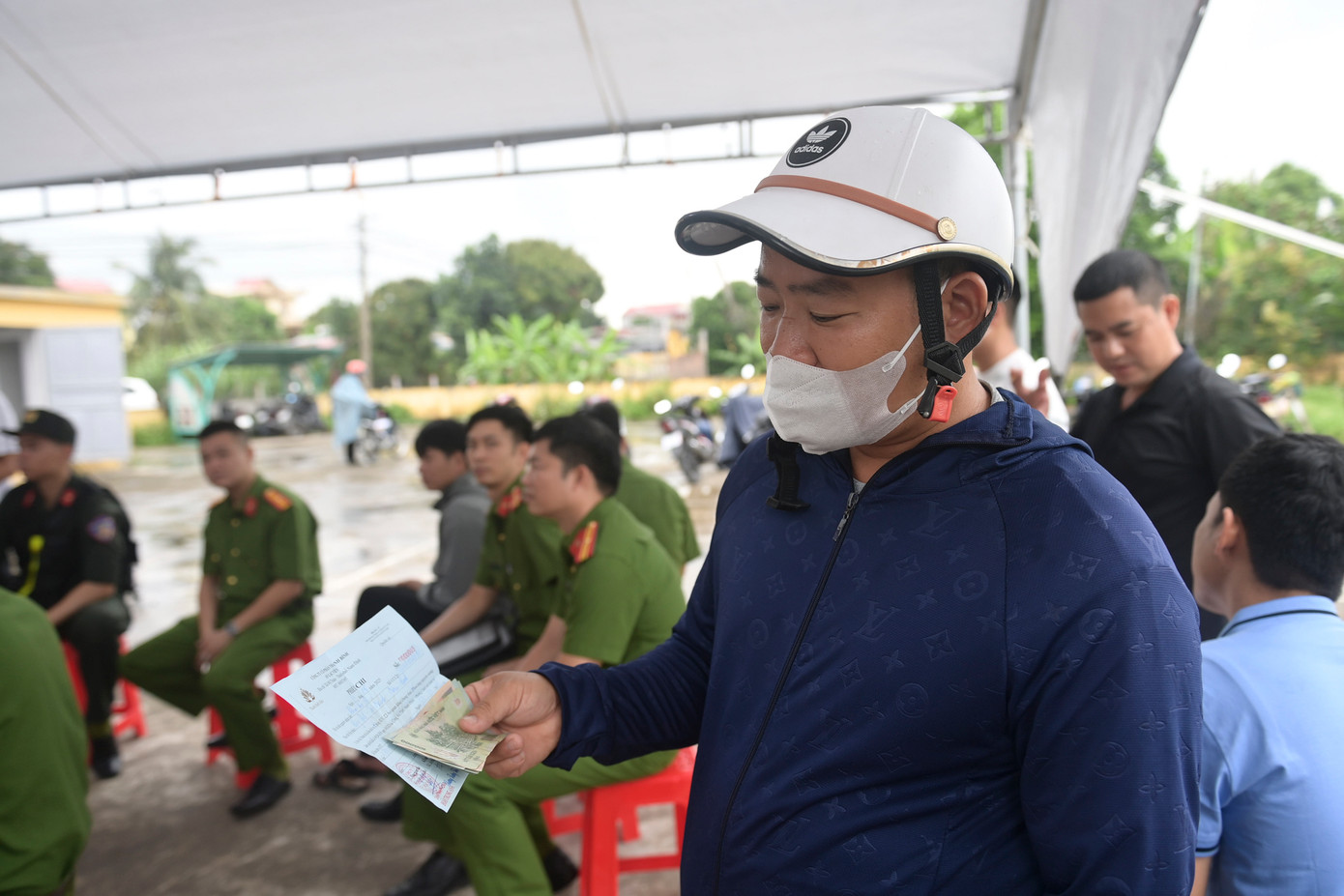 Lực lượng công an hỗ trợ việc trả và nhận lại tiền. Lực lượng công an hỗ trợ việc trả và nhận lại tiền.