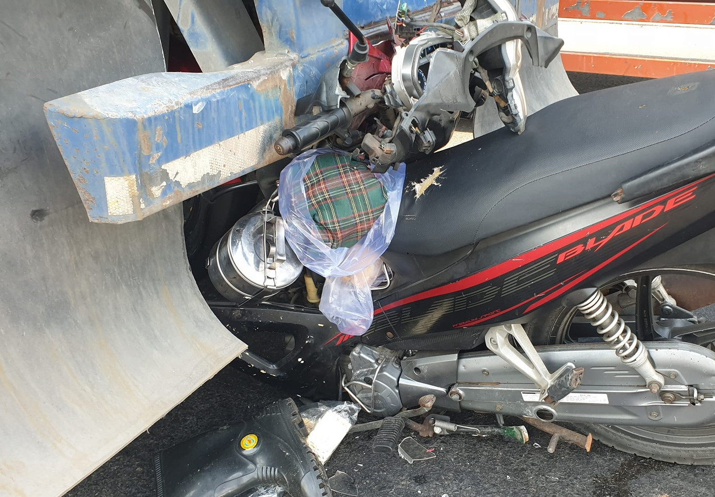 Xe máy dính chặt vào đuôi xe container