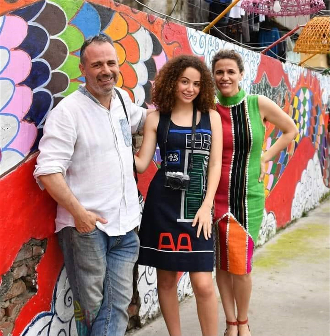 Vợ chồng Diego và con gái lớn bên tác phẩm tranh tường của anh ở Phúc Tân. Ảnh: FBNV