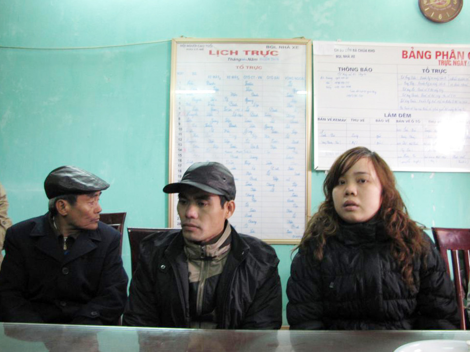 Chị Phạm Thị Minh (ngoài cùng bên phải)cùng chồng Nguyễn Văn Anh (giữa) trình báo sự việc với ban quản lý nhà xe. Ảnh: Tuấn Nguyễn