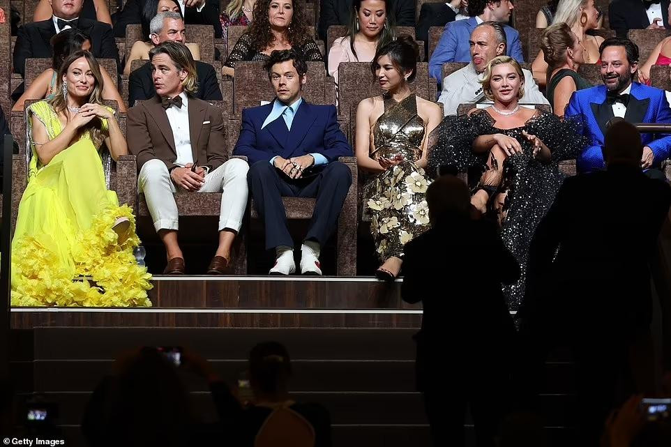 Dù đạo diễn và các diễn viên chính đến buổi ra mắt phim với tâm trạng phấn chấn nhưng có thể nhận thấy điểm bất thường. Olivia và Harry là người yêu của nhau nhưng không có tương tác gì, lúc xem phim cũng không ngồi cạnh nhau. Harry và Florence là cặp đôi chính của phim nhưng cũng rất lạnh nhạt với nhau. Trước đó, truyền thông quốc tế rộ lên tin đồn giữa Olivia và Florence xảy ra mâu thuẫn liên quan đến Harry. Những người trong cuộc không lên tiếng về tin đồn này nhưng rõ ràng giữa họ không hề hòa thuận.