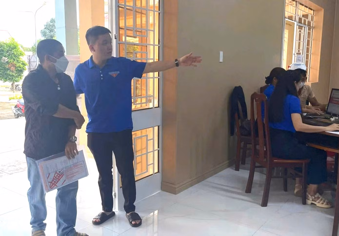 Người dân được tình nguyện viên hướng dẫn vào nộp hồ sơ
