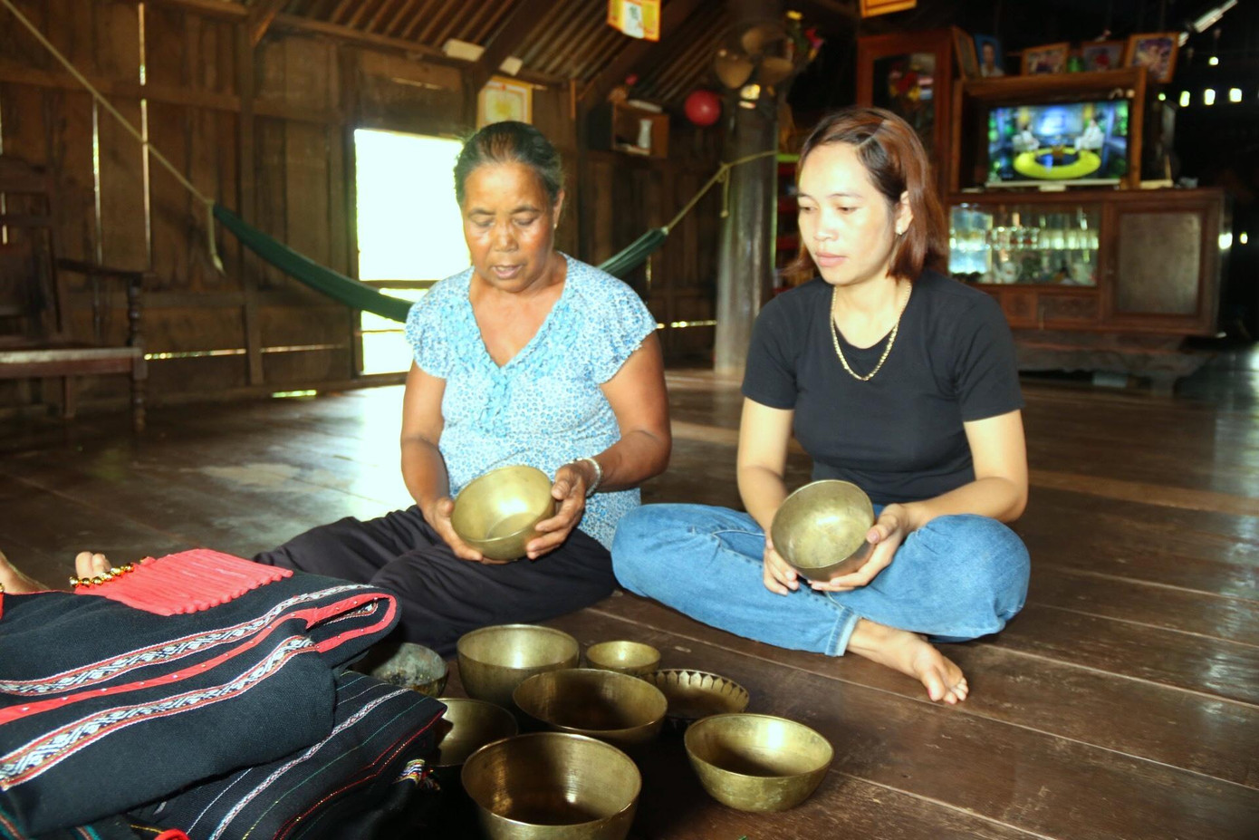 Bà H'Wik mua lại bộ chén đồng để đựng thức ăn và rượu cần cúng dâng lên thần linh Bà H'Wik mua lại bộ chén đồng để đựng thức ăn và rượu cần cúng dâng lên thần linh
