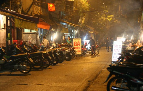 Con phố ngắn nhưng có tới cả chục tiệm treo biển món ăn này tạo thành một “quần thể chân gà nướng” vô cùng đông vui tấp nập.