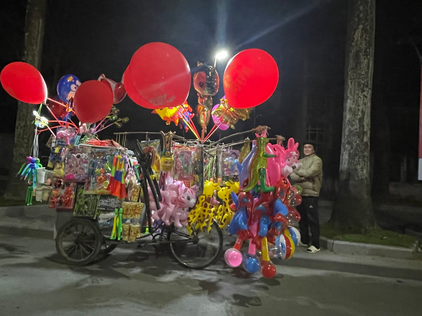 Trên đại lộ Lê Lợi, phường Điện Biên (TP Thanh Hoá) một số người bán hàng rong chờ đợi những người đi chơi đêm giao thừa đến mua hàng là đồ chơi cho trẻ nhỏ...