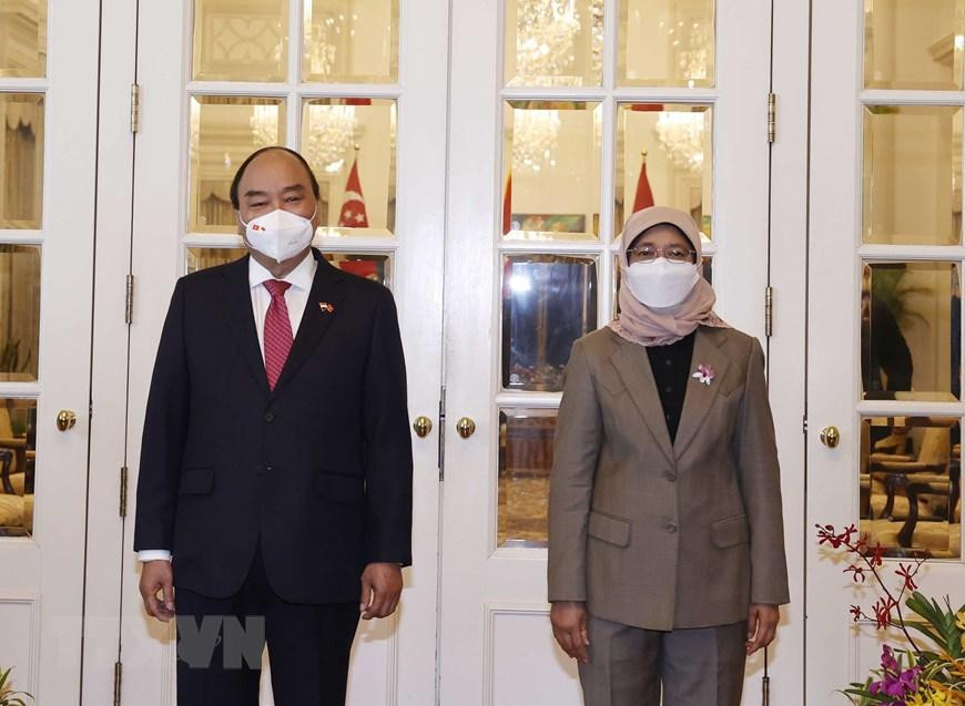 Chủ tịch nước Nguyễn Xuân Phúc chụp ảnh chung với Tổng thống Cộng hòa Singapore Halimah Yacob. (Ảnh: Thống Nhất/TTXVN)