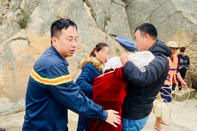 Lực lượng chức năng cùng người dân dìu người phụ nữ vào nơi an toàn (Ảnh: Phòng Cảnh sát PCCC&amp;CNCH).