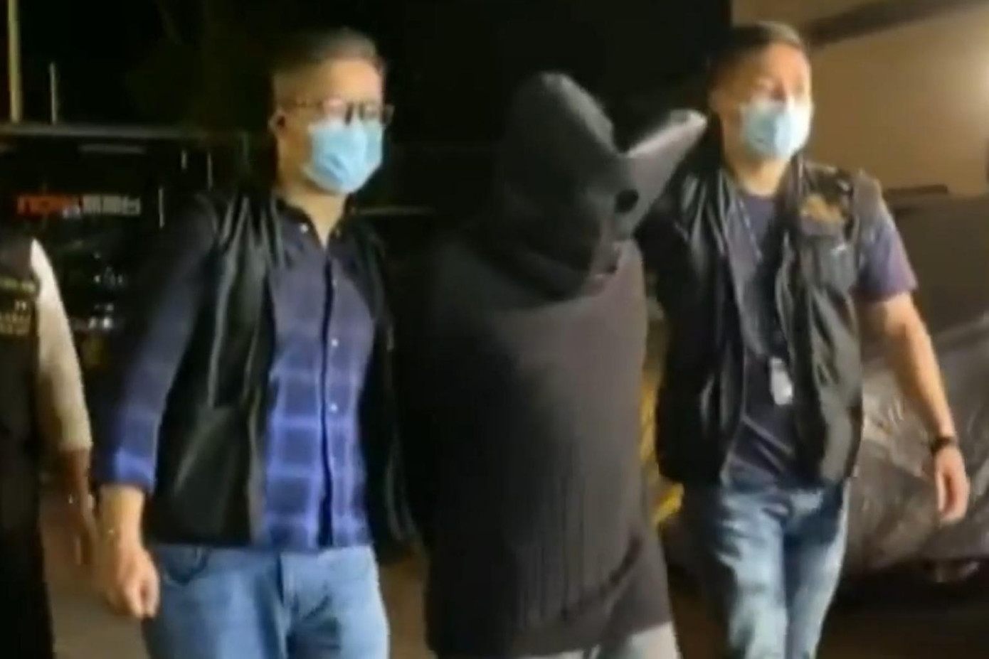 Nghi phạm (ở giữa) khi bị bắt. Ảnh: Straistimes