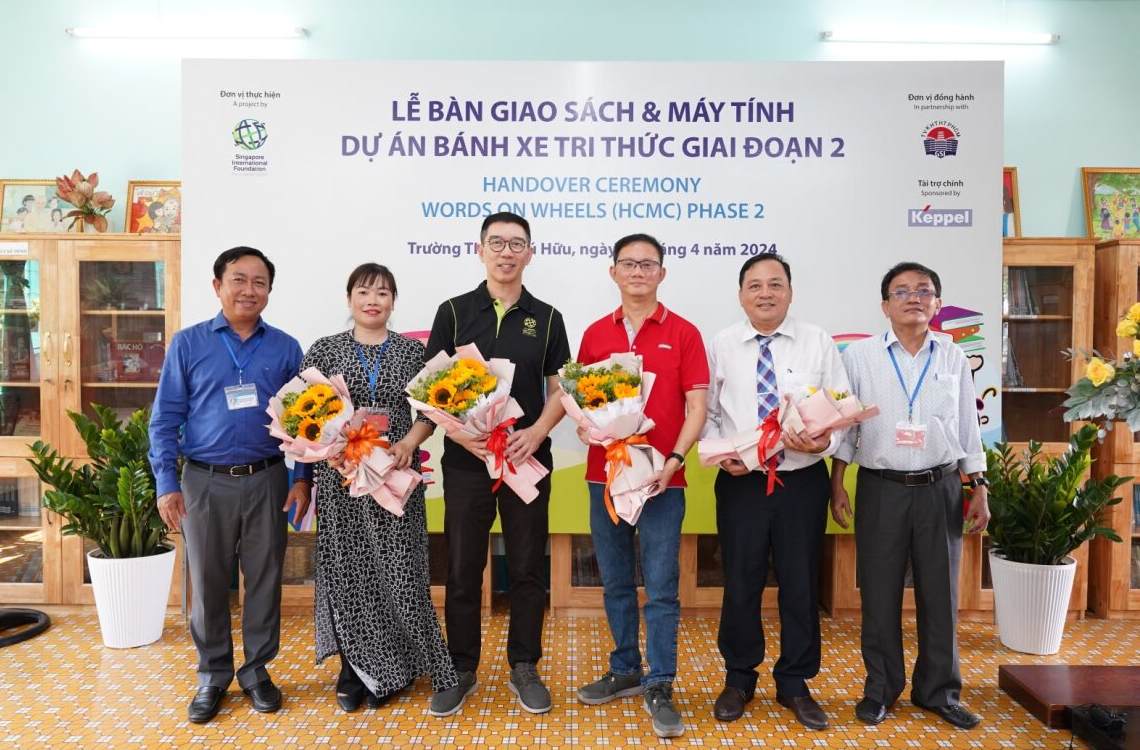 Đại diện Keppel, Quỹ quốc tế Singapore và Thư viện Khoa học Tổng hợp TP.HCM nhận hoa từ trường.