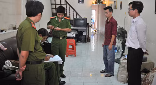 Cơ quan CSĐT Công an TP.HCM thực hiện lệnh khám xét nơi ở của Nguyễn Đức Đông Anh (áo đỏ sẫm) - Ảnh: Diệp Đức Minh 