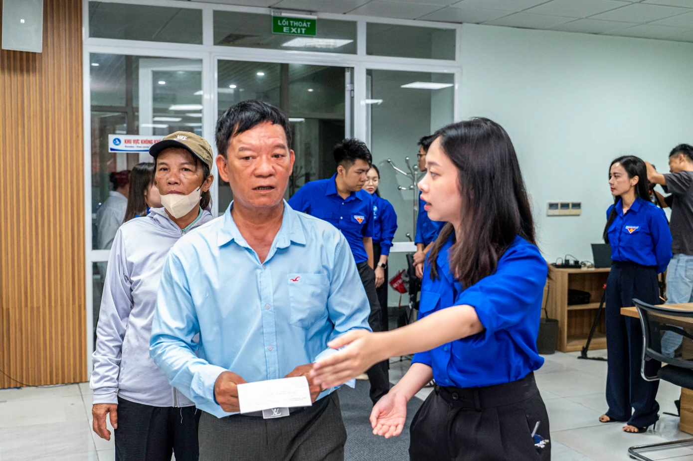 Lực lượng đoàn viên, thanh niên hướng dẫn người dân lấy số và vào các quầy tương ứng để làm thủ tục.