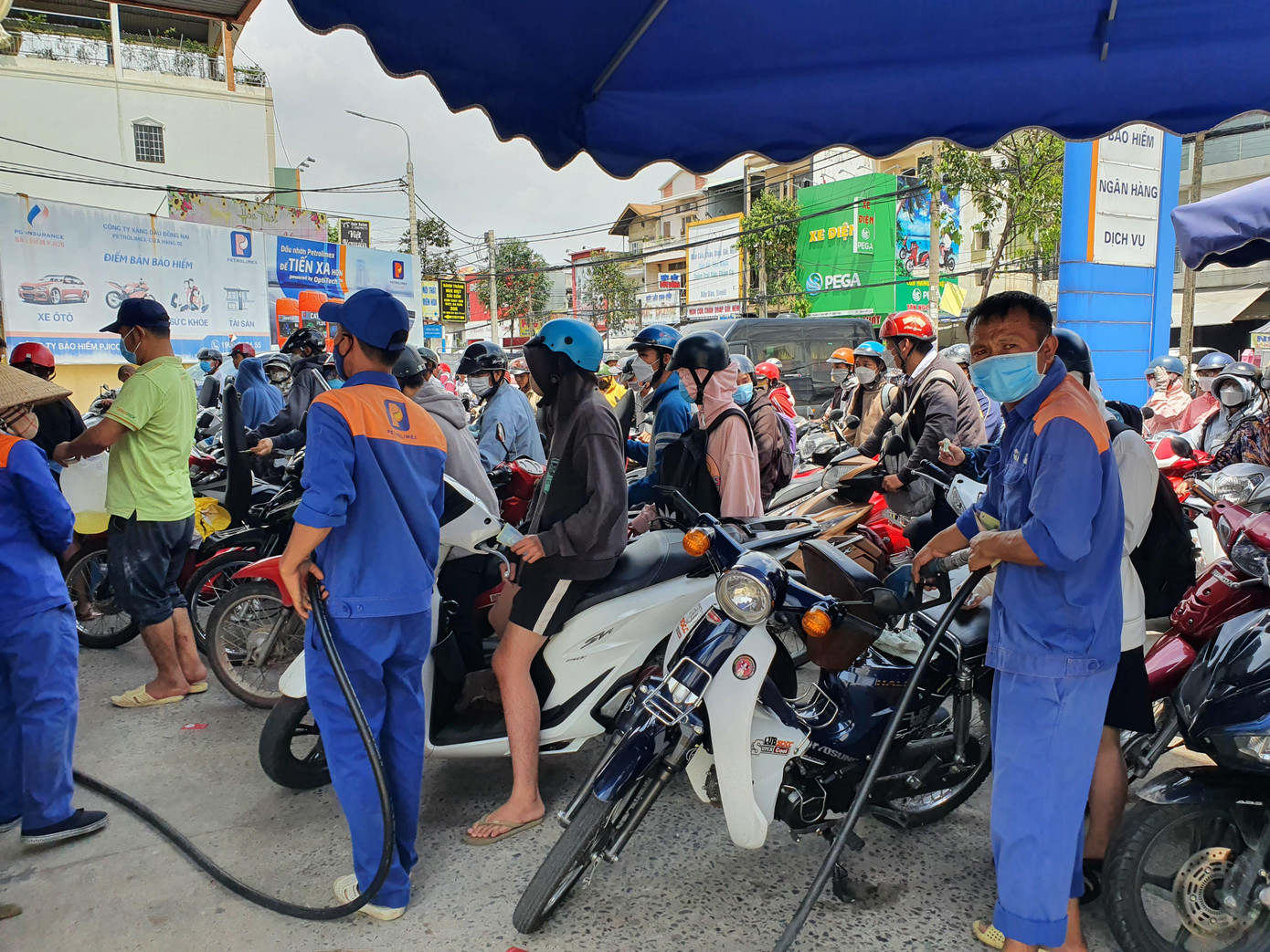 Nhân viên bơm xăng luôn tay tại 1 trạm xăng.