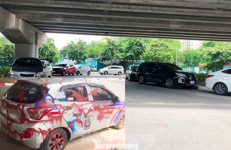 Khu vực gầm cầu đường Vành đai 3 (đối diện tòa VP6) cũng đang trở thành nơi trông xe thu phí ngày đêm. Đây cũng là vị trí xe taxi hãng G7 bị tạt sơn khắp thân xe (ảnh nhỏ). Trước khi vụ này xảy ra, người dân ở đây cho biết đã có nhiều vụ xe người dân đỗ cũng bị tương tự như vậy.