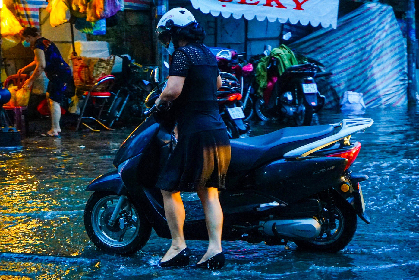 Nhiều người phải dẫn bộ do xe bị "chết máy" sau khi lưu thông qua chỗ ngập sâu tại giao lộ đường Calmette và Nguyễn Thái Bình, Quận 1.