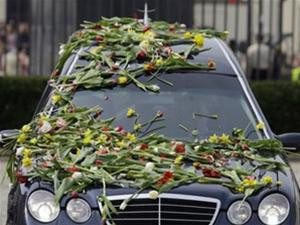 Chiếc xe chở quan tài phu nhân tổng thống được tung đầy hoa tuy líp