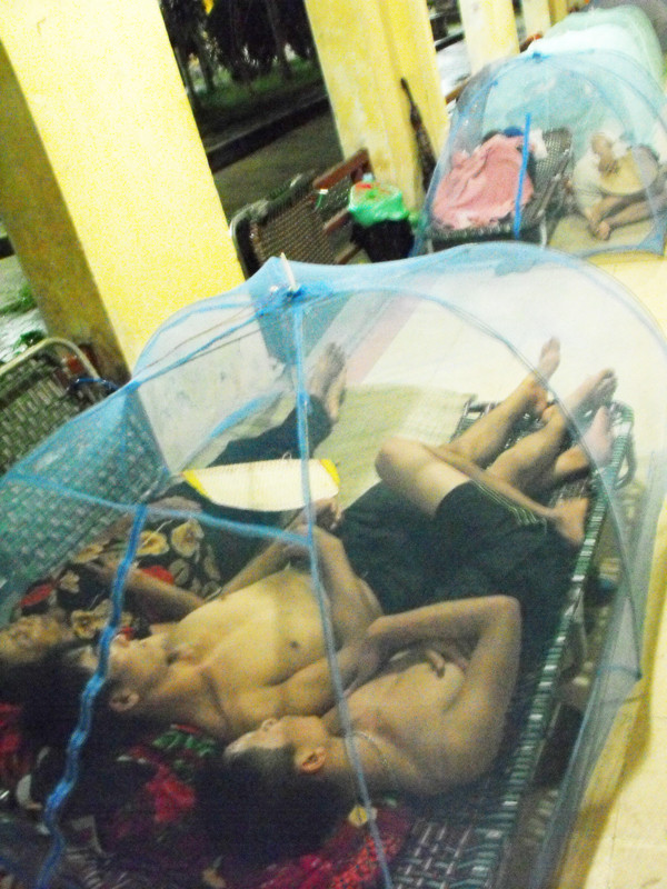 Chen lưng trong chiếc màn chụp chật hẹp. Mỗi giường có giá khoảng 250.000 đồng, màn chụp giá 150.000 đồng. Ngoài ra, họ còn phải mua ổ khóa giá 50.000đ để giữ giường khỏi mất cắp khi đi khám bệnh hoặc ra ngoài. Chen chúc trong chiếc màn chụp chật hẹp