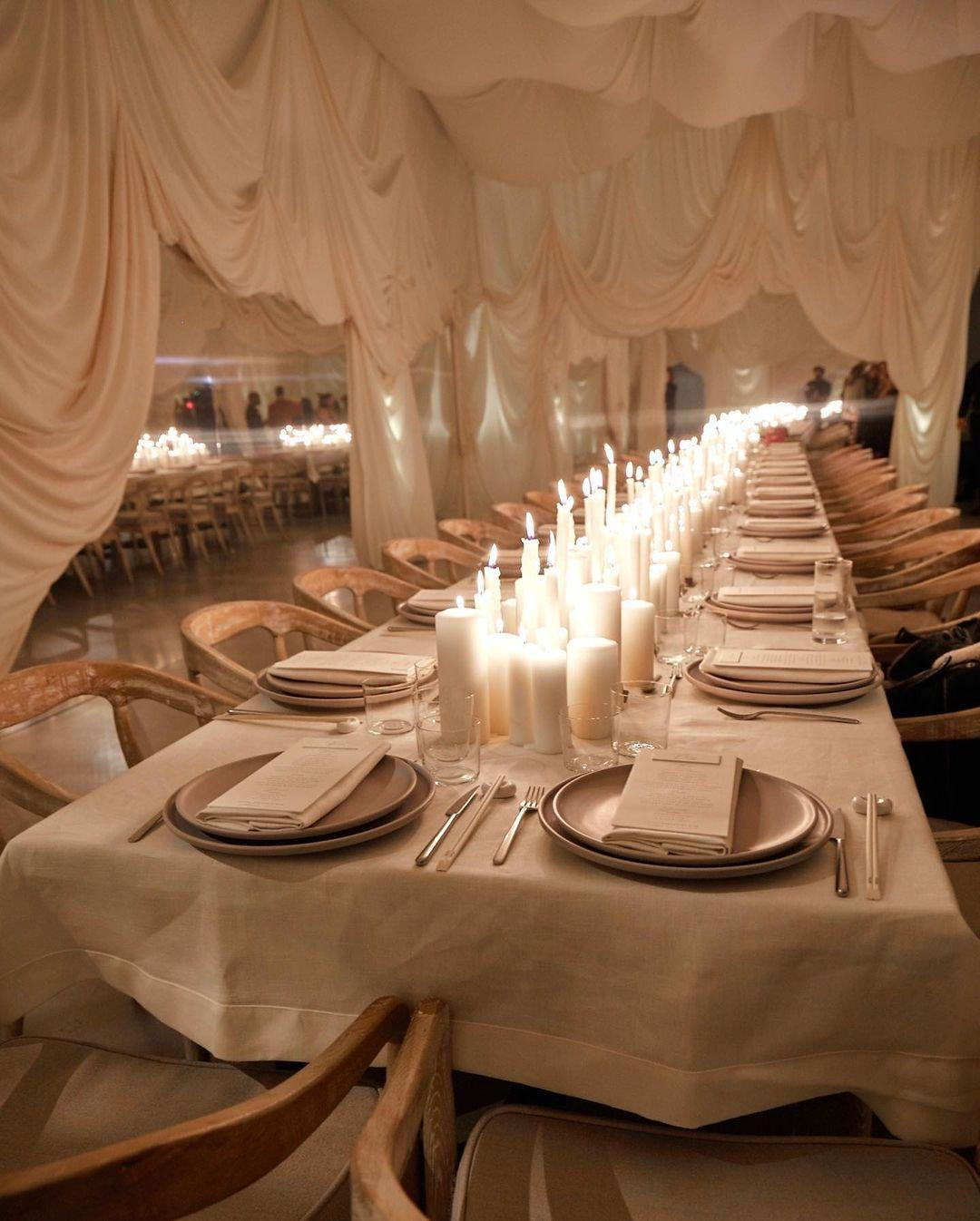 Bữa tiệc diễn ra ở thành phố Calabasas, ngoại ô Los Angeles, California, Mỹ. Không gian được trang trí theo phong cách lãng mạn, cổ điển với ánh nến lung linh và rèm trắng. Kim đãi khách món sushi và cocktail. Ảnh: Instagram.