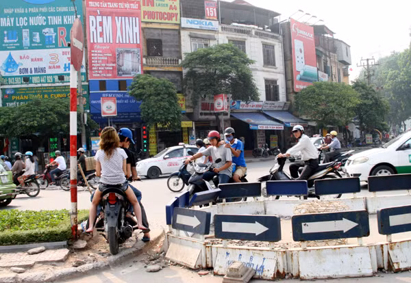 Trên đường Nguyễn Chí Thanh (đoạn tiếp giáp với đường Trần Duy Hưng) nhiều người và phương tiện len lỏi trèo qua dải phân cách