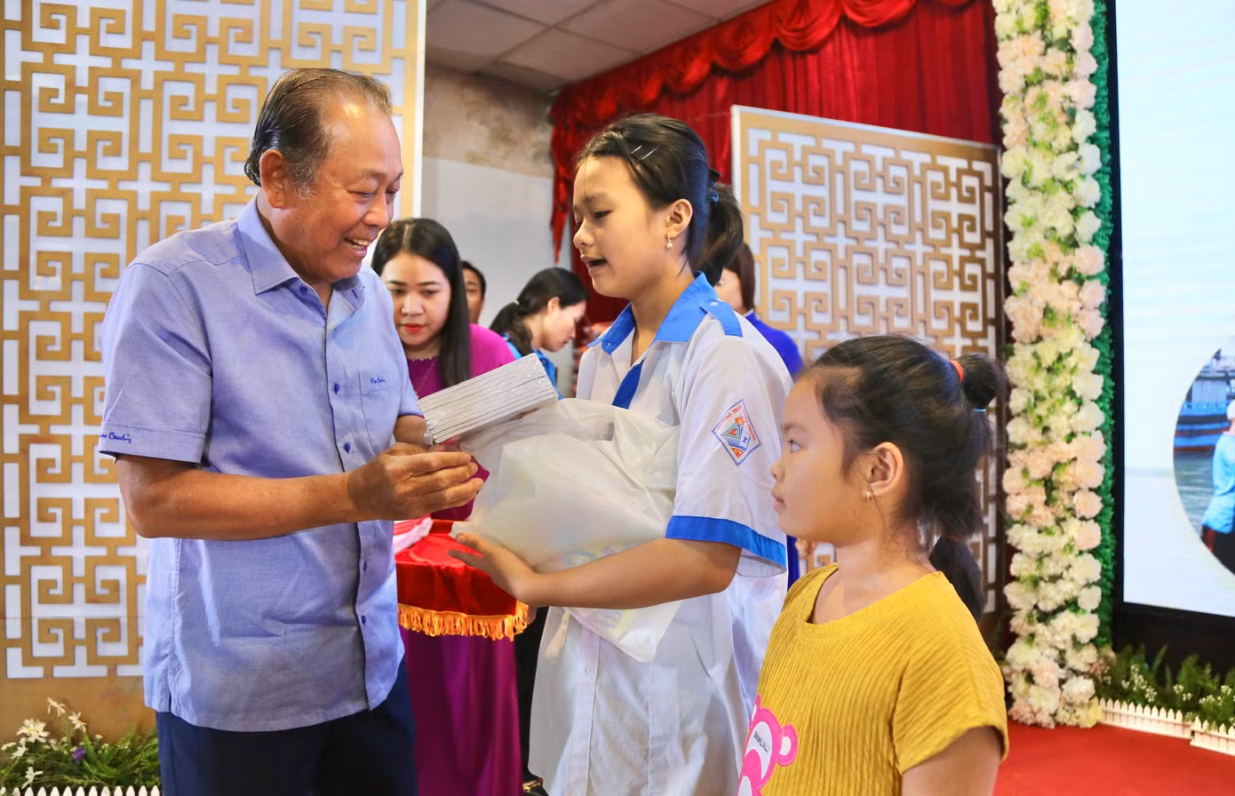 Ông Trương Hòa Bình, nguyên Phó Thủ tướng Thường trực Chính phủ trao học bổng cho học sinh.