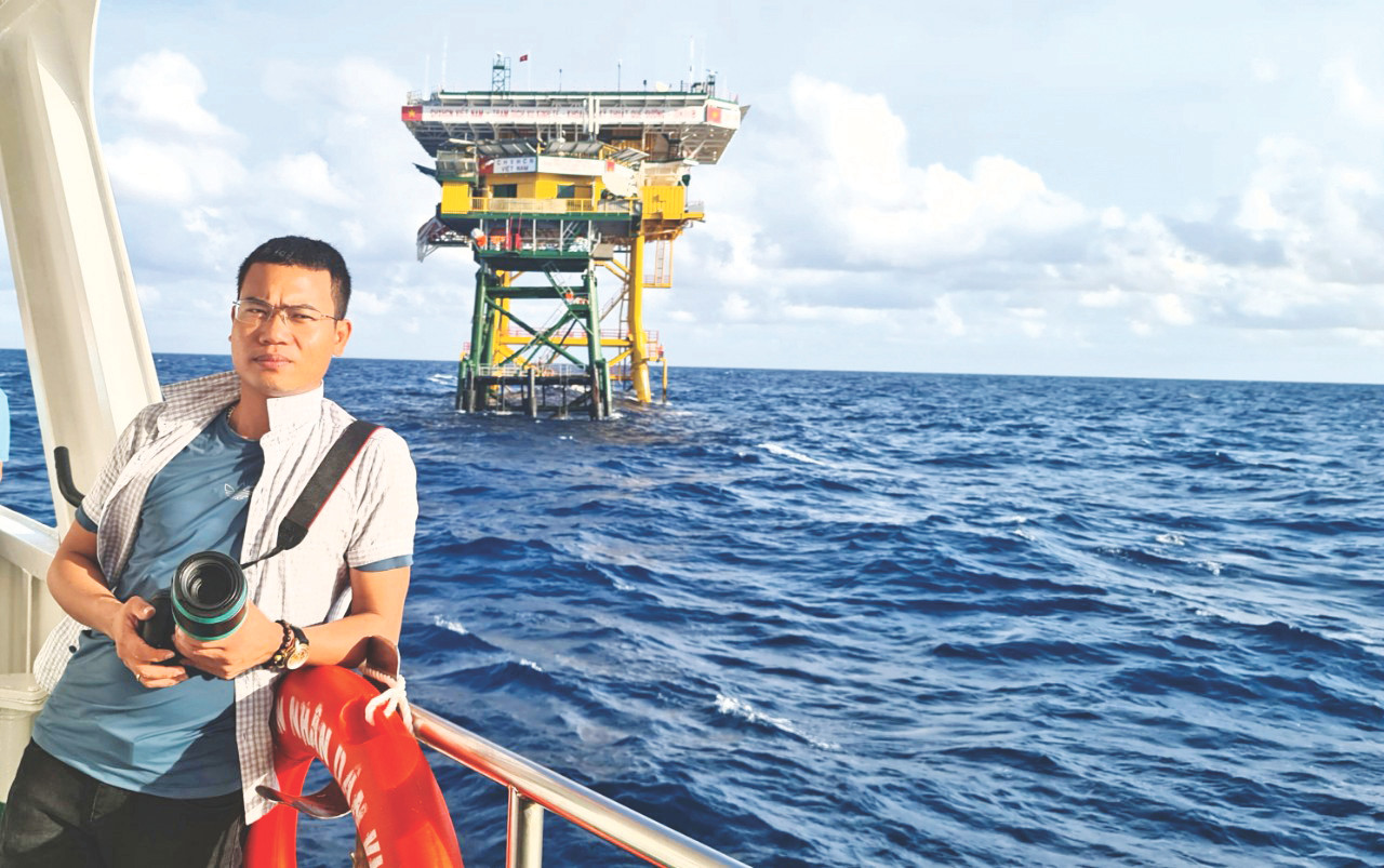 Phóng viên Nguyễn Cảnh Huệ trước Nhà giàn DK1/8 Phóng viên Nguyễn Cảnh Huệ trước Nhà giàn DK1/8