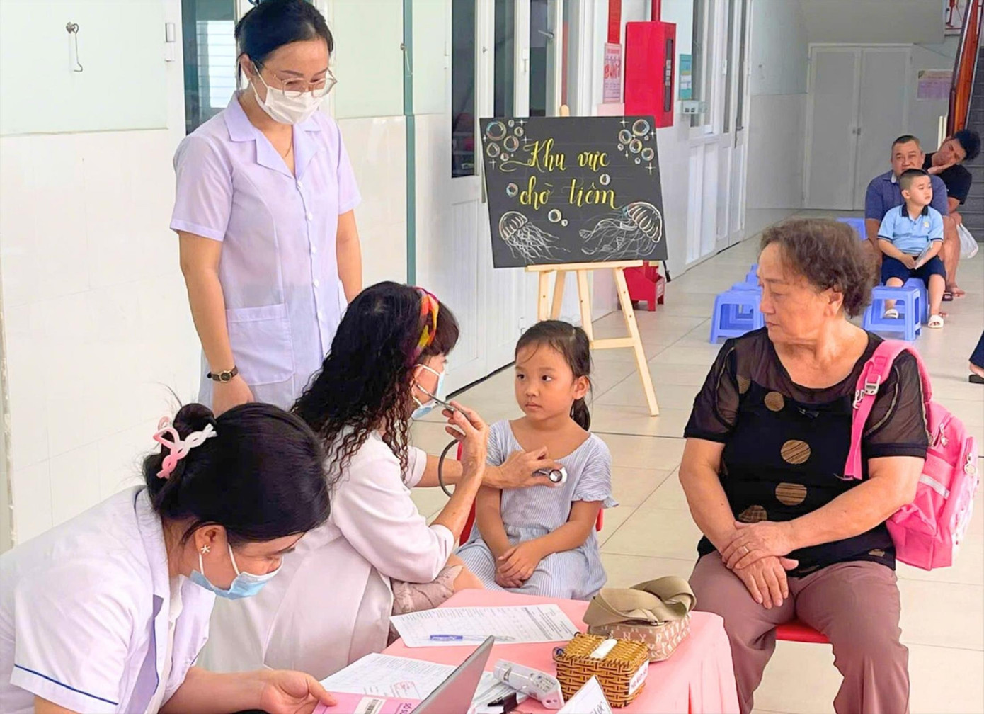 Bác sĩ khám sàng lọc sức khỏe cho học sinh ở quận 7, TPHCM trước khi tiêm vắc xin phòng bệnh sởi ảnh: Phú Khánh