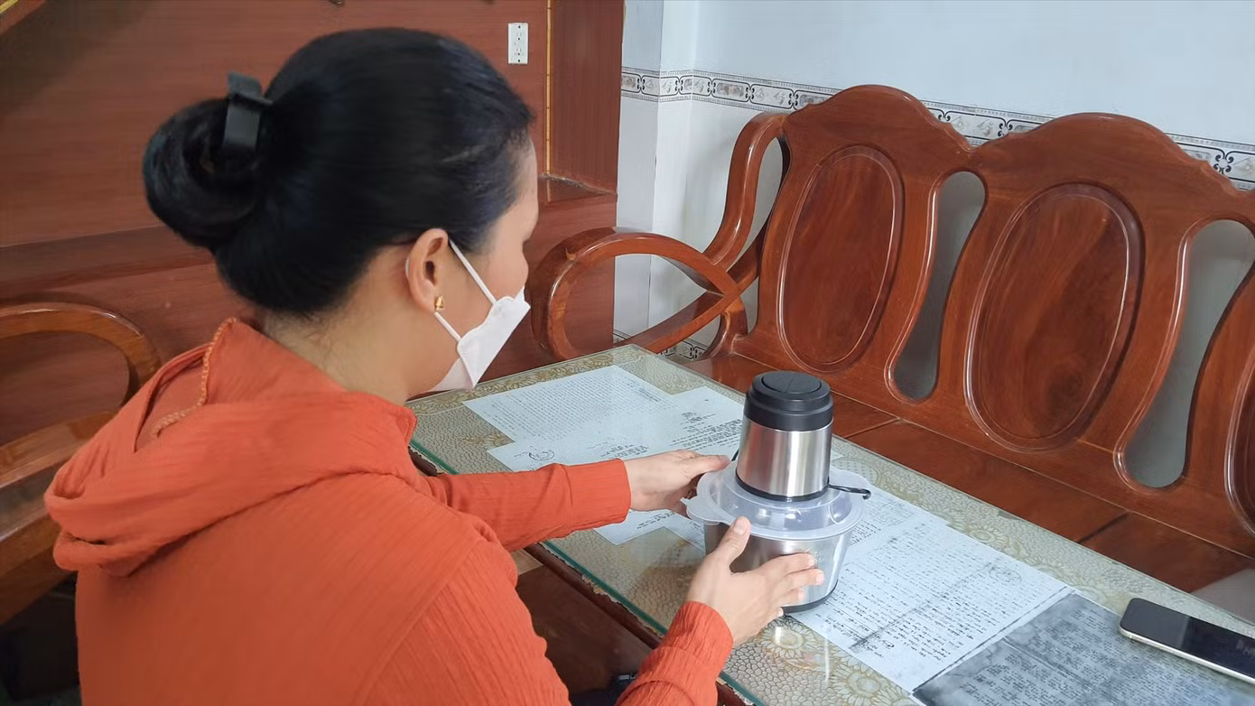 Bà N và máy xay thịt từ chương trình quà tặng tri ân. Ảnh: Hoàng Thuận