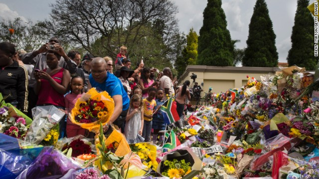 Đông đảo người dân, có cả trẻ nhỏ tới viếng thăm và đặt hoa bên ngoài nhà ông Mandela tại Johannesburg, hôm 7/12.