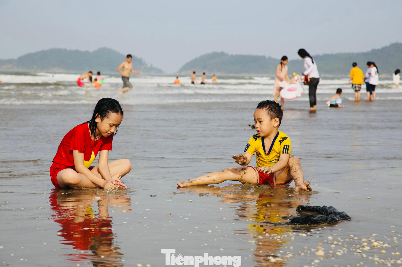 Những đứa trẻ vui mừng khi được bố mẹ đưa đi tắm biển trong ngày nghỉ lễ.