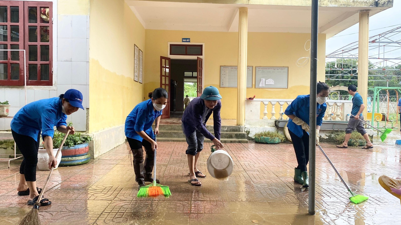 Áo xanh tình nguyện cùng quét dọn lại sân trường.